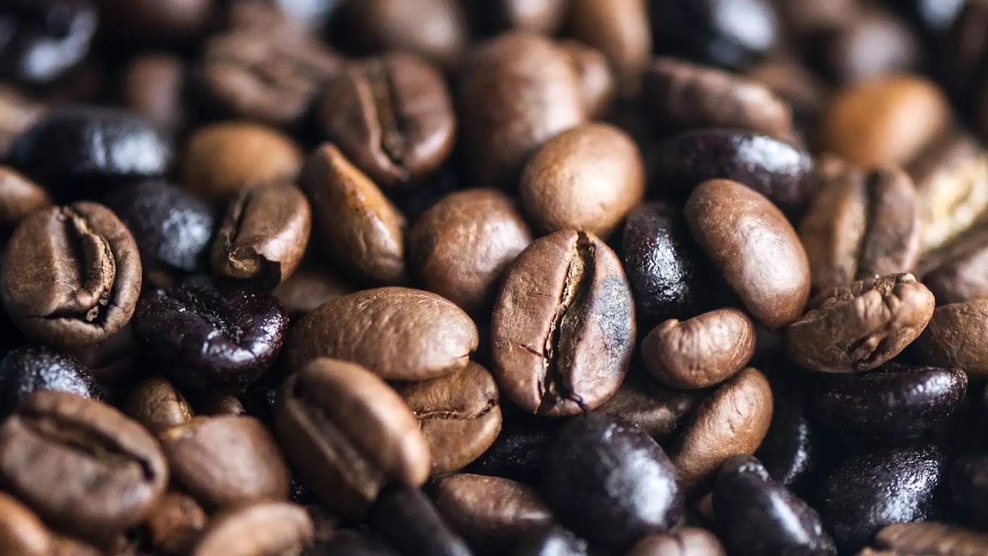 A cropped close-up of a pile of coffee beans.